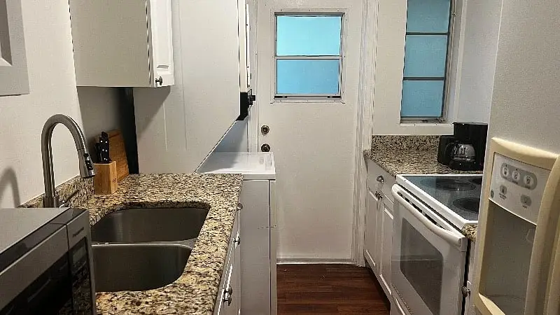 Kitchen sink and granite counter, looking toward the back door