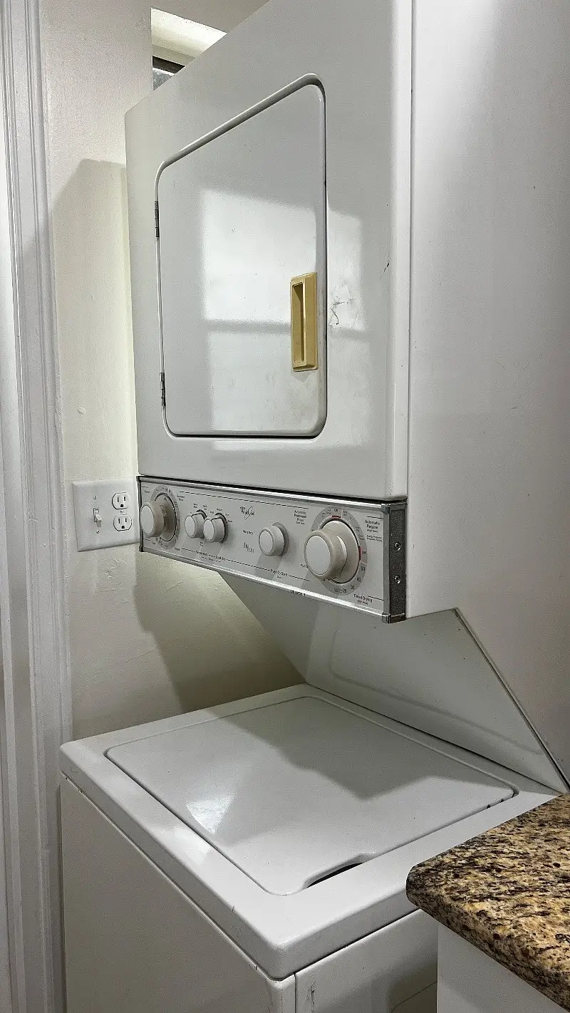 Stacked washer and dryer in a closet inside the unit