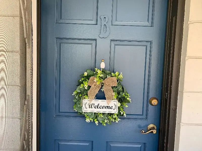 The blue front door, marked B, with a wreath on it
