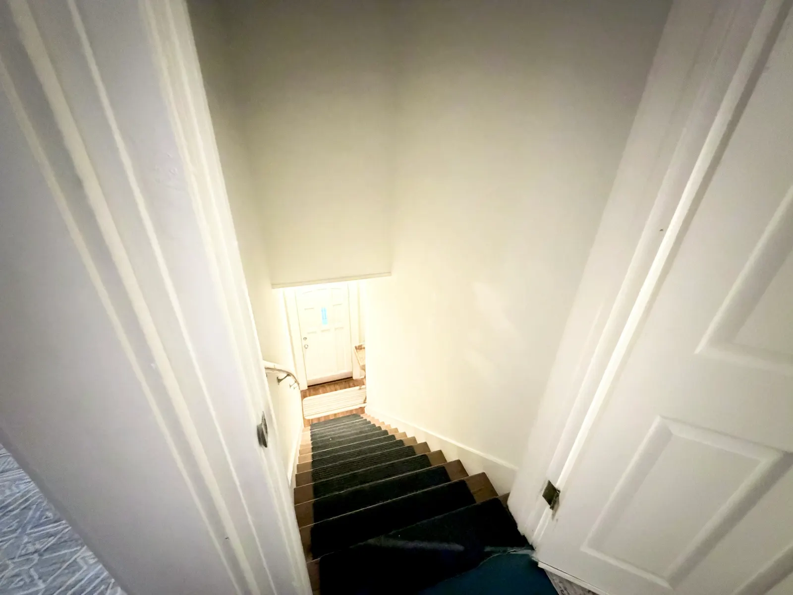 The stairs down from the unit to its entrance door at street level