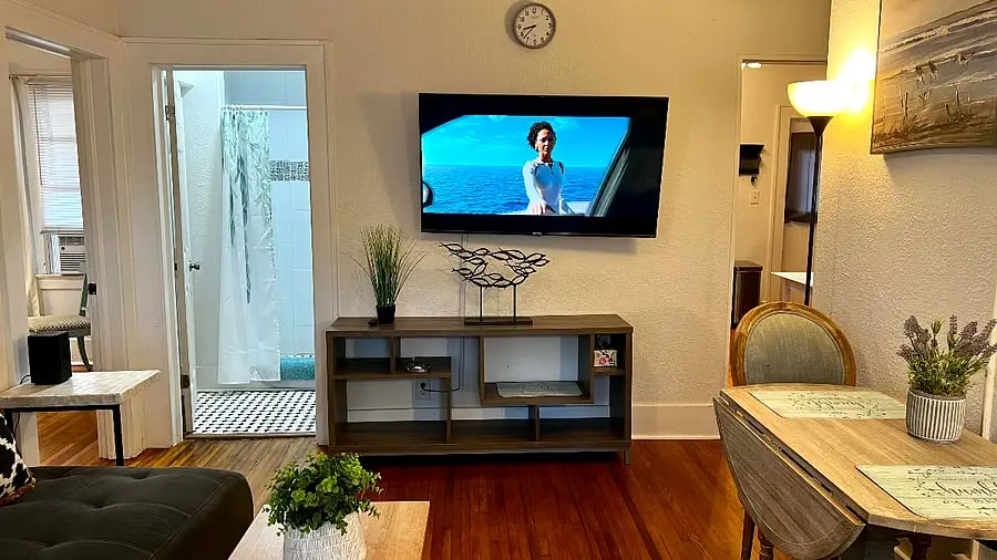 Living room with the television on the wall above a media console