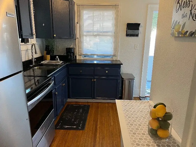 Kitchen with deep blue cabinets and an electric range