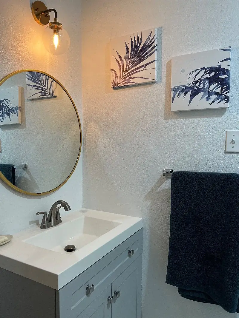 Bathroom vanity with a round mirror above the sink